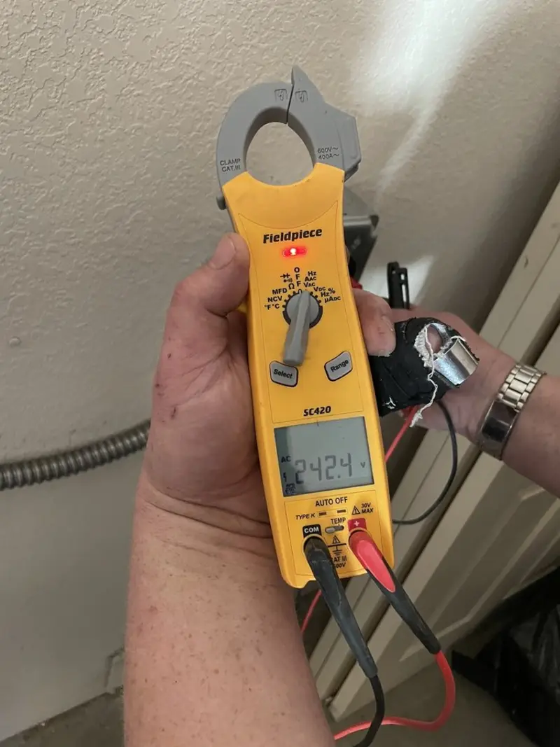Voltage testing with clamp meter during Electrical Installation Services in Holly